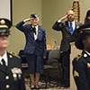 Two female color guard team members presenting the Colors; Ms. Vivian Cunningham, Chaplain Rubin Ortiz, and Ms. Aaliyah Kew